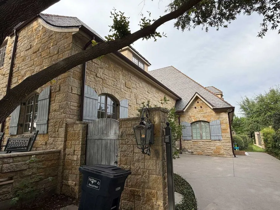 Exterior of a North Texas brick home with a finished roof
