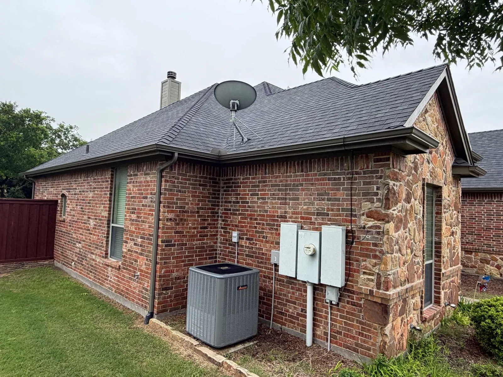 Seamless gutter run along the edge of a brick home